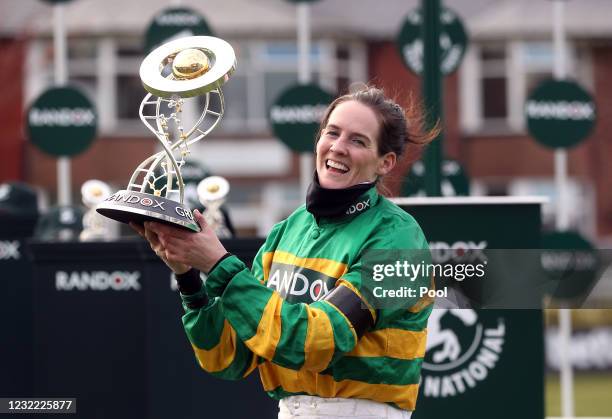 Jockey Rachael Blackmore receives the Randox Grand National Handicap Chase trophy after winning on Minella Times on Grand National Day of the 2021...