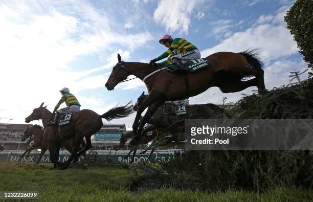 Runners and riders clear the water jump during the Randox Grand National Handicap Chase, on Grand National Day of the 2021 Randox Health Grand...