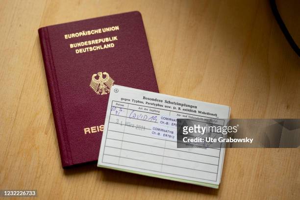 Bonn, Germany In this photo illustration a travel and vaccination passport with proof of Corona vaccination on April 05, 2021 in Bonn, Germany.