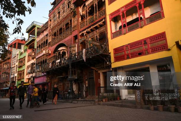 People walk in a shuttered food street in Lahore on April 11 as a lockdown was imposed to control the spread of the Covid-19 coronavirus.