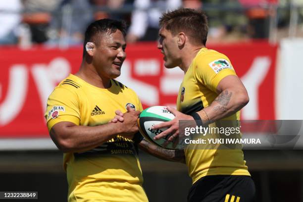 Suntory Sungoliath's Australian Sean McMahon celebrates with teammate Yukio Morikawa after scoring a try during the Japan Rugby Top League match...