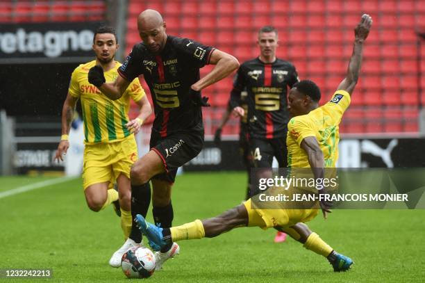 Rennes' French midfielder Steven Nzonzi fights for the ball with Nantes' Malian defender Charles Traore during the French L1 football match between...