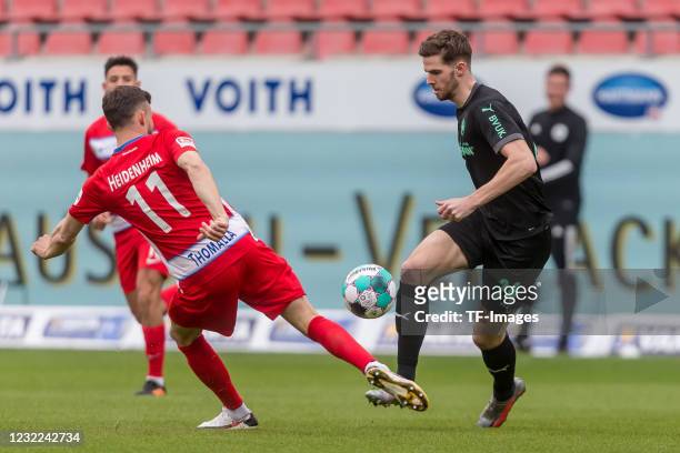 Denis Thomalla of 1.FC Heidenheim 1846 and Anton Stach of SpVgg Greuther Fuerth battle for the ball during the Second Bundesliga match between 1. FC...