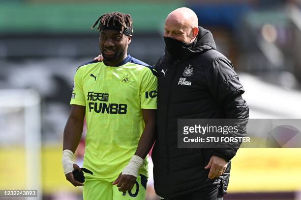 Newcastle United's French midfielder Allan Saint-Maximin celebrates with Newcastle United's First Team Coach Steve Agnew after winning the English...