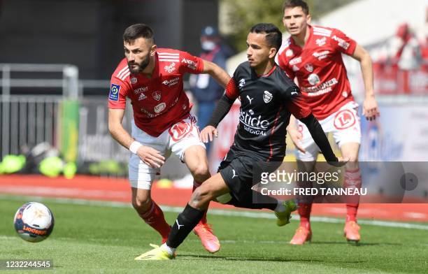 Brest's French forward Franck Honorat fights for the ball with Nimes' French defender Sofiane Alakouch during the French L1 football match between...