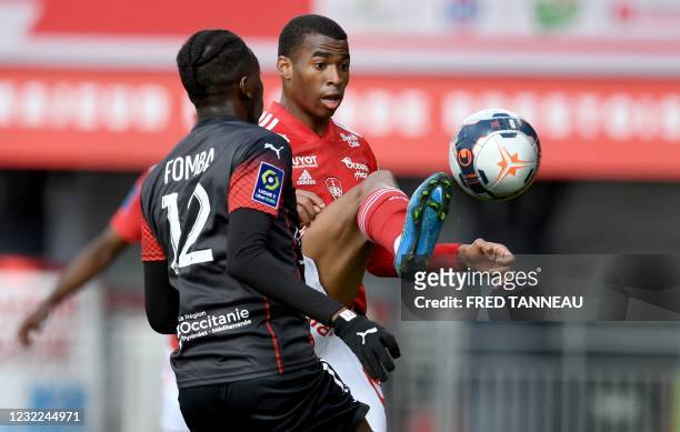 Brest's Brazilian midfielder Jean Lucas fights for the ball with Nimes' French midfielder Lamine Fomba during the French L1 football match between...