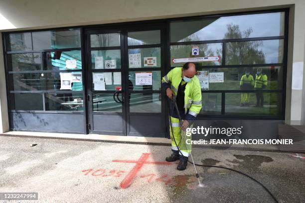 Municipal worker cleans sprayed graffiti outside the Avicenna Islamic Cultural center discovered by early morning Muslim worshippers in Rennes,...