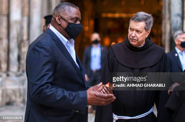 Defence Secretary Lloyd Austin speaks with Franciscan monks outside the Church of the Holy Sepulchre, traditionally believed to be the burial site of...