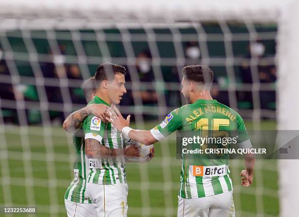 Real Betis' Spanish midfielder Cristian Tello celebrates his goal with teammates during the Spanish League football match between Real Betis and Club...