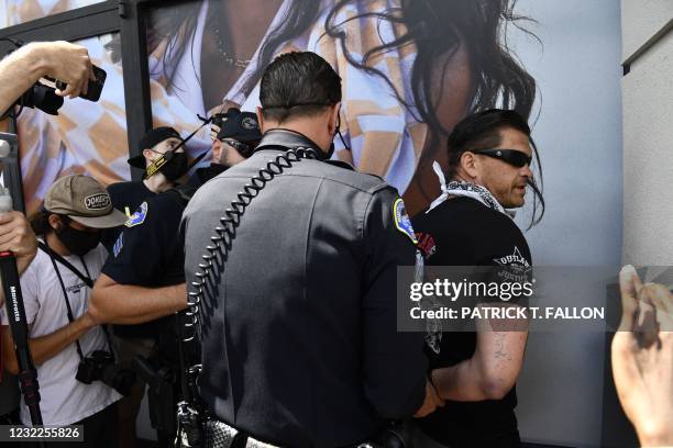 Some protesters are arrested as others gather during a demonstration for a "White Lives Matter" march and rally on April 11, 2021 in Huntington...