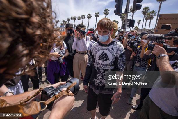 Rally supporter stares down a person with a camera at a "White Lives Matter" rally on April 11, 2021 in Huntington Beach, California. The rally was...