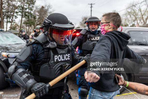 Protesters confront police officers in riot gear after an officer shot and killed a black man in Brooklyn Center, Minneapolis, Minnesota on April...
