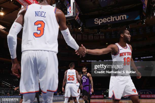 Alec Burks hi-fives Nerlens Noel of the New York Knicks during the game against the Toronto Raptors on April 11, 2021 at Madison Square Garden in New...