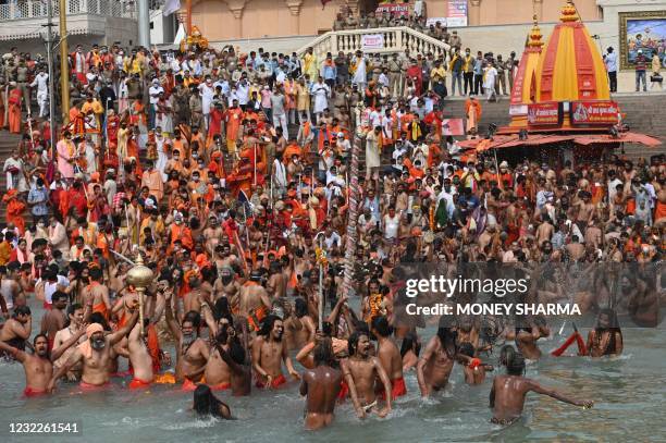 Naga Sadhus take a holy dip in the waters of the Ganges River on the day of Shahi Snan during the ongoing religious Kumbh Mela festival, in Haridwar...