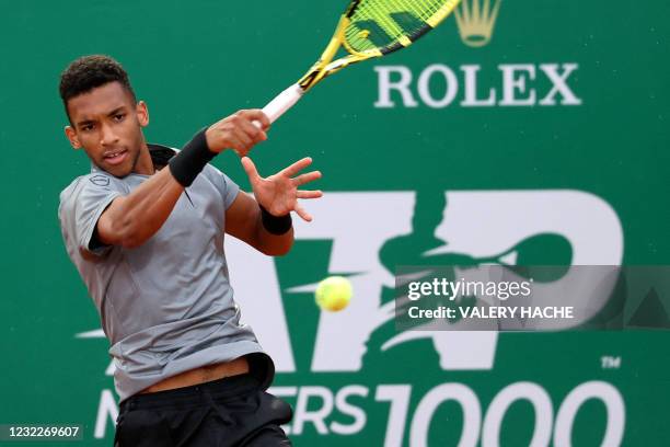 Canada's Felix Auger-Aliassime returns the ball to Chile's Cristian Garin during their first round singles match on day two of the Monte-Carlo ATP...