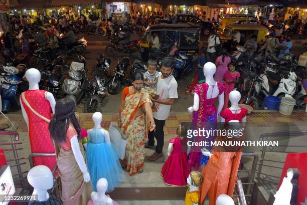 People shop for new clothes on the eve of Ugadi festival in Bangalore on April 12, 2021.