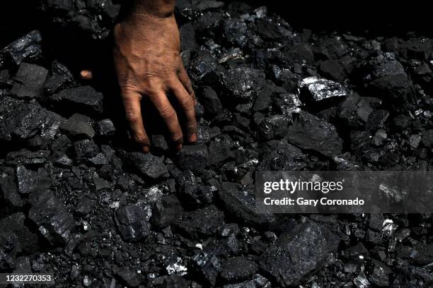 Miners separate pieces of coal on Thursday, March 25, 2021 in Sabinas, Coahuila. Mexico once embraced renewable energies. Now President Andres Manuel...