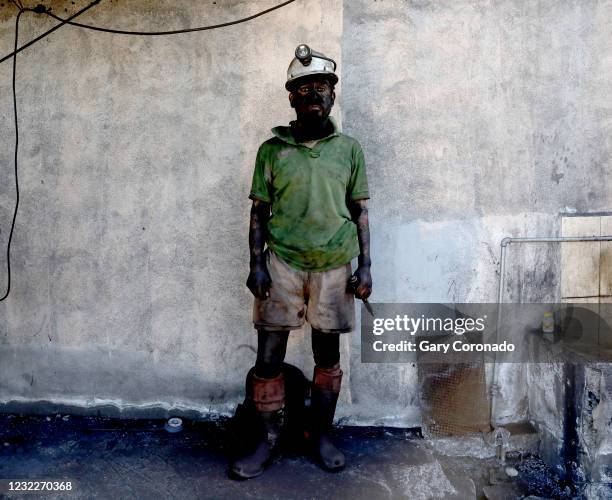 Miner Javier Cardenas mining for only four months, after coming to the surface mining for coal at Mina Santa Barbara coal mine near the town of Aura...