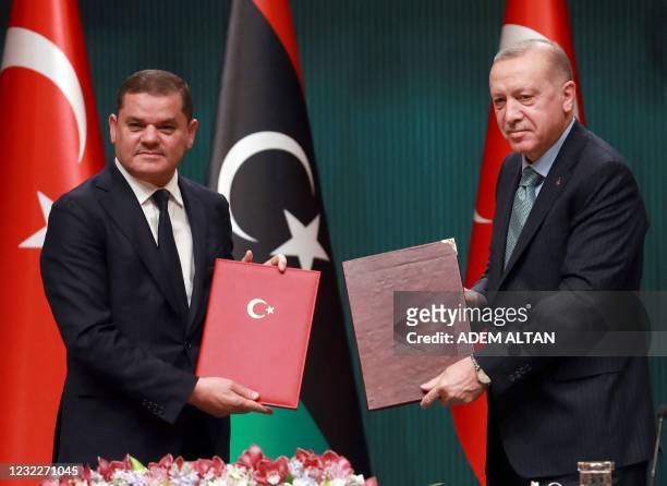 Turkish President Recep Tayyip Erdogan and Libyan Government of National Unity Prime Minister Abdul Hamid Dbeibah pose for a photo during a signing...