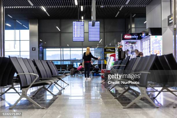 Passengers are seen waiting at nearly empty Krakow Airport as many International flights are canceled due to ongoing Covid-19 pandemic and national...