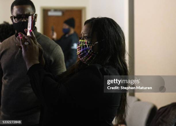 Lawyer and activist Nekima Levy Armstrong reacts as she watches the body camera footage of the killing of 20-year-old Daunte Wright as it played...