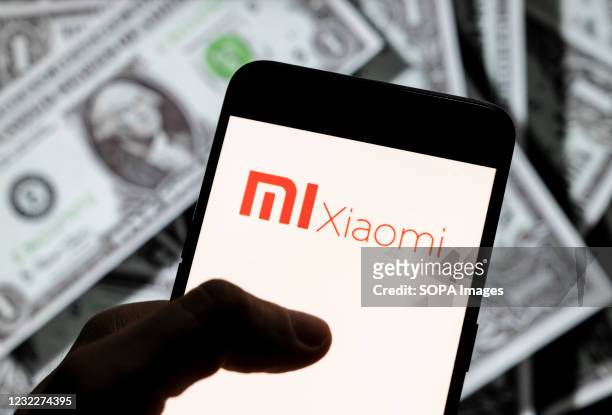 In this photo illustration, the Chinese electronics manufacturer company Xiaomi logo seen on an Android mobile device screen with the currency of the...