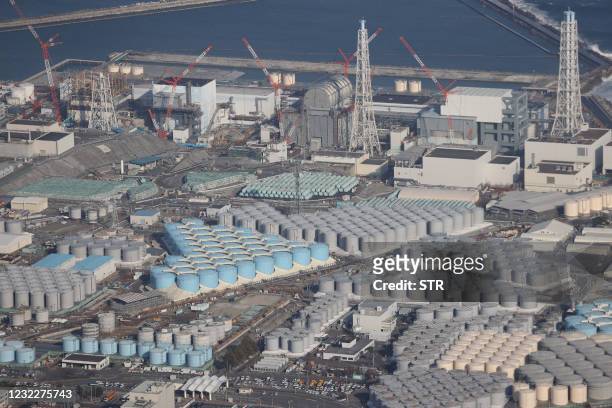 This picture taken on February 14, 2021 shows an aerial view of the TEPCO's Fukushima Daiichi Nuclear Power Plant undergoing decommissioning work and...