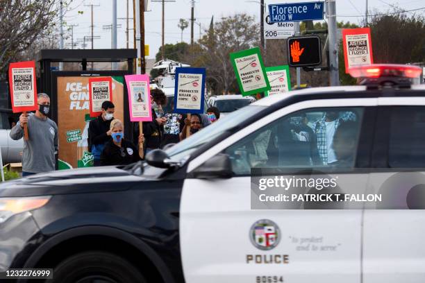 An LAPD vehicle drives past as people protest the killings of people by police including the death of George Floyd and Daunte Wright on April 12,...