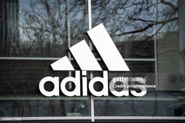 April 2021, Berlin: The company's logo hangs on the façade of the Adidas store on Tauentzienstrasse. Big brand manufacturers like Adidas, Miele and...