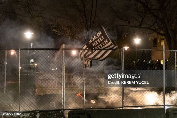 Black Lives Matter flag is seen after curfew as demonstrators protest the death of Daunte Wright who was shot and killed by a police officer in...