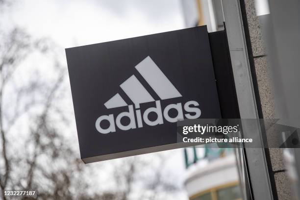 April 2021, Berlin: The company's logo hangs on the façade of the Adidas store on Tauentzienstrasse. Big brand manufacturers like Adidas, Miele and...