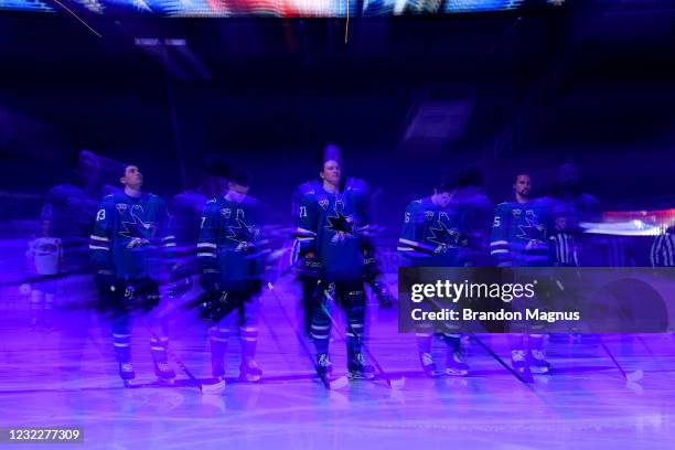 Nikolai Knyzhov, Dylan Gambrell, John Leonard, Ryan Donato and Erik Karlsson of the San Jose Sharks stand for the National Anthem before the game...