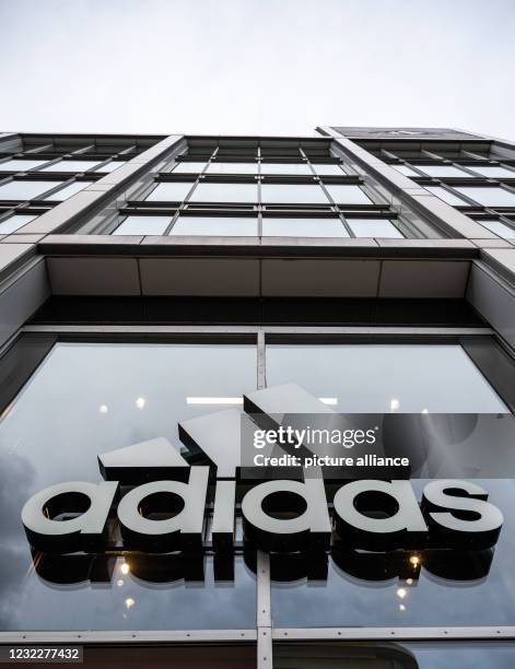 April 2021, Berlin: The company's logo hangs on the façade of the Adidas store on Tauentzienstrasse. Big brand manufacturers like Adidas, Miele and...