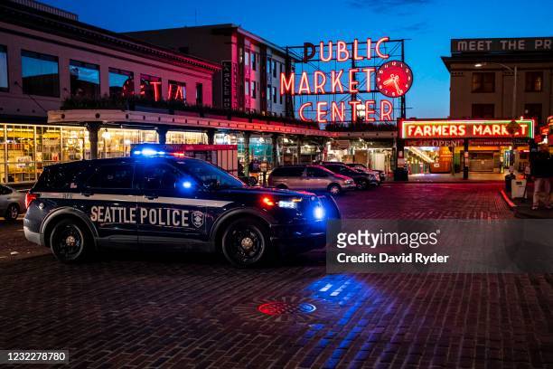 Police vehicle follows behind a group of demonstrators near Pike Place Market as they protest the death of Daunte Wright on April 12, 2021 in...