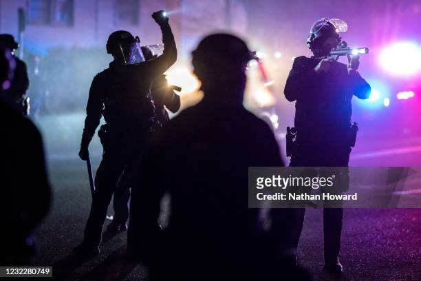 Portland police officers search for stragglers after dispersing a riot during a protest against the killing of Daunte Wright on April 12, 2021 in...