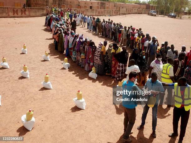 Muslims living in Mali's Segou receive aid packages prepared with the donations of Turkish people and distributed by Turkey Diyanet Foundation , in...