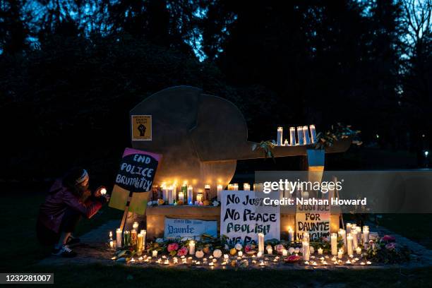 Person lights candles at a vigil for Daunte Wright on April 12, 2021 in Portland, Oregon. Wright, a Black man whose car was stopped in Brooklyn...