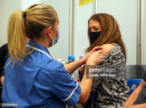 Caroline Nicolls receives an injection of the Moderna Covid-19 vaccine administered by nurse Amy Nash, at the Madejski Stadium on April 13, 2021 in...