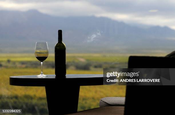 Detail of a bottle and glass of wine seen at the restaurant of DiamAndes, a winery in the Uco Valley, San Carlos Department, in the Argentine...