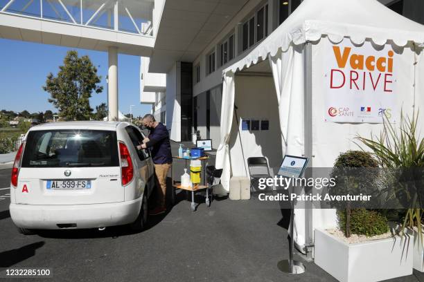 Person in the car gets vaccinated in the first Vaccidrive in France on April 13, 2021 in Saint-Jean-de-Vedas, France. The drive-in vaccinations will...