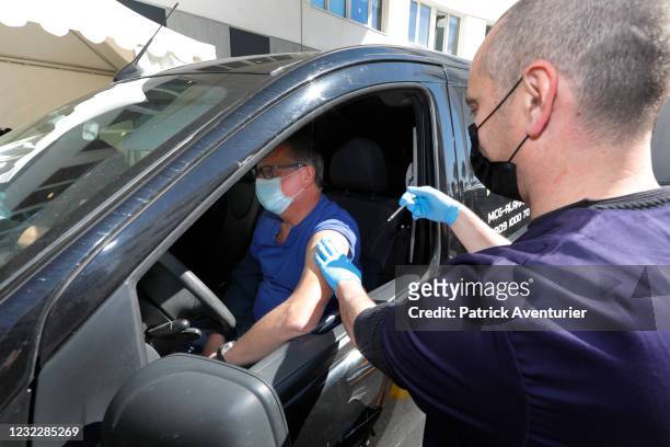 Person in the car gets vaccinated in the first Vaccidrive in France on April 13, 2021 in Saint-Jean-de-Vedas, France. The drive-in vaccinations will...