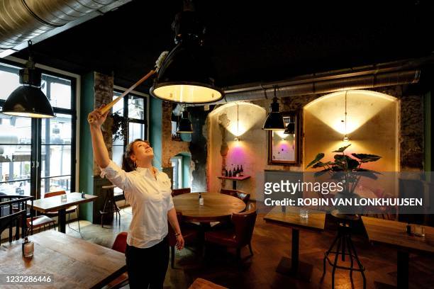 Staff members cleans during preparations at Cafe Ubica, which has taken several precautions ahead of its temporary Fieldlab reopening in Utrecht on...