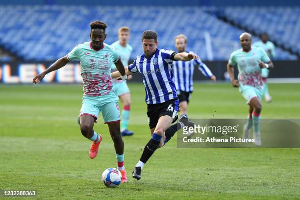 Jamal Lowe of Swansea City battles with Sam Hutchinson of Sheffield Wednesday during the Sky Bet Championship match between Sheffield Wednesday and...
