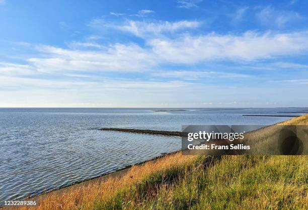 view of the waddensea from the dyke in vlieland, the netherlands - vlieland stock pictures, royalty-free photos & images