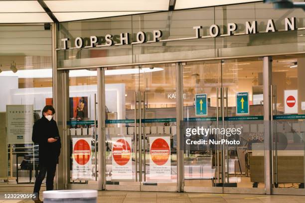 A man is seen in a store front of Topshop in city center of Duesseldorf, Germany on April 13, 2021 as Duesseldorf launches with shopping with...