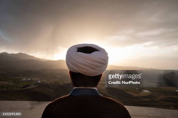 An Iranian cleric stands in the Imam Ali observatory as he tries to find the new moon of Muslims holy month of Ramadan in Kahak area near the holy...