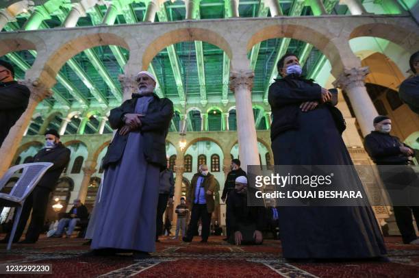 Muslim worshippers perform the evening Tarawih prayer during the holy month of Ramadan, at the Umayyad Mosque in the Syrian capital Damascus, on...