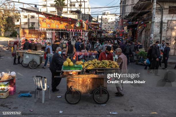 People buy food on the first day of the holy month of Ramadan in Al-Zawiya market in Old Gaza on April 13, 2021 in Gaza City, Gaza. Millions of...