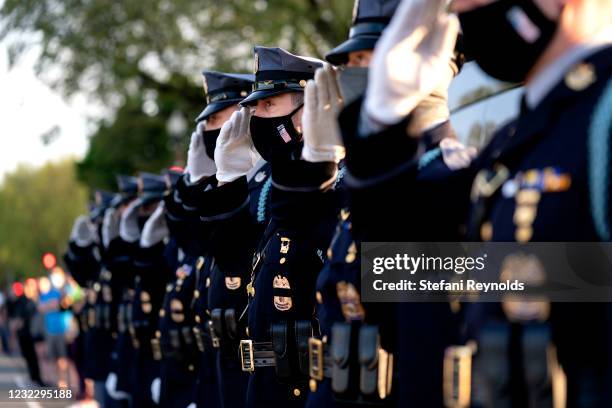 Police Officers from Prince Georges County, Maryland, salute as the hearse carrying U.S. Capitol Police Officer William Evans proceeds past the U.S....