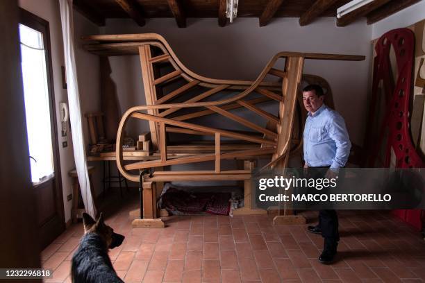Italian piano craftsman Luigi Borgato stands in his workshop in Borgo Veneto, near Padua on April 8, 2021. - Italian craftsman Luigi Borgato grew his...